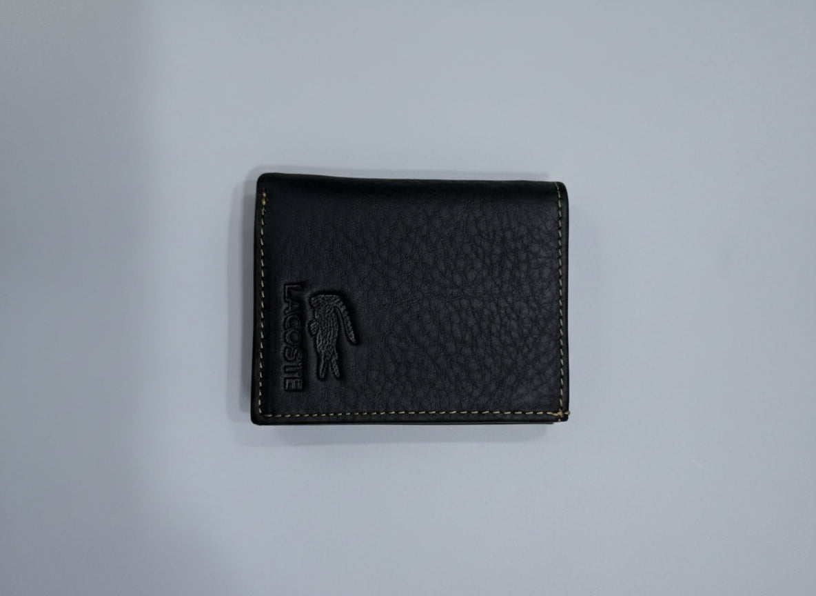 Black leather wallet with brand logo on a textured gray surface