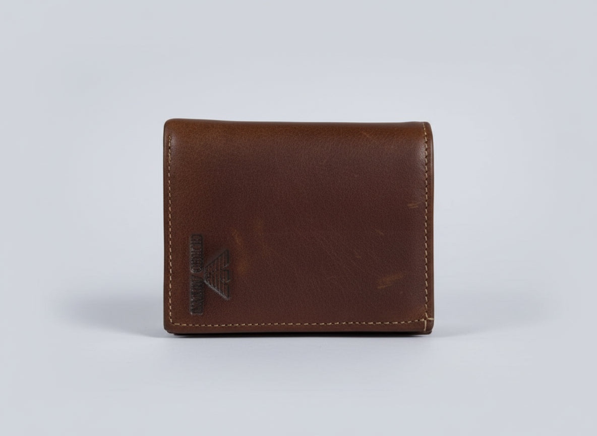 Brown leather wallet with a brand logo on a transparent background