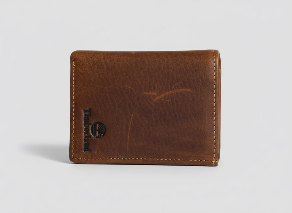 Brown leather wallet with a brand logo on a clear background
