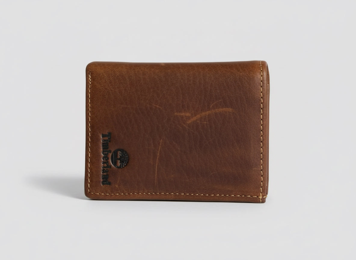 Brown leather wallet with a brand logo on a clear background
