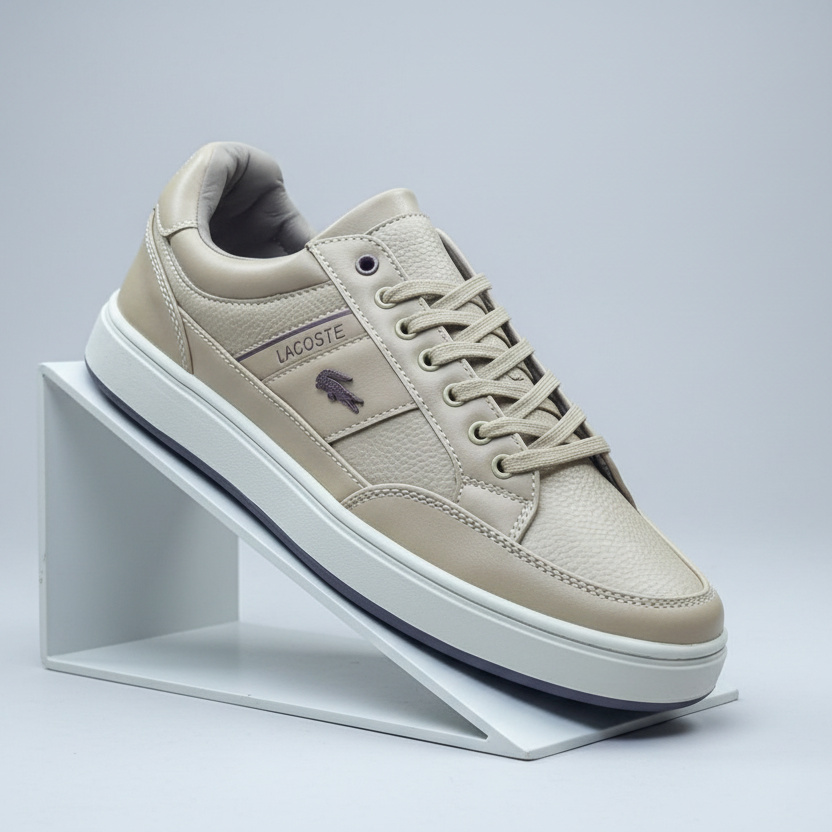 Beige Lacoste sneaker on a white stand against a light gray background