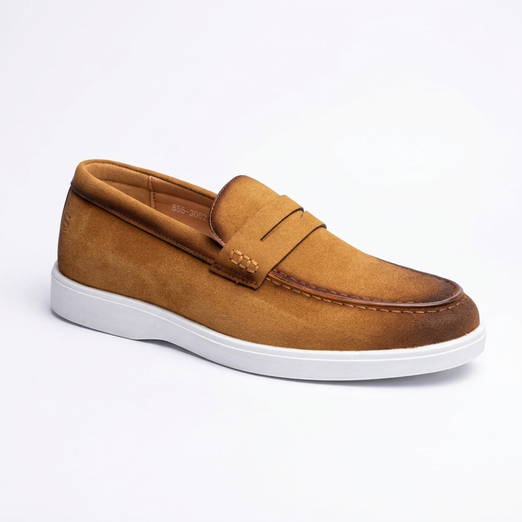 Tan men's penny loafer with apron-toe stitching and contrasting white sole on white background