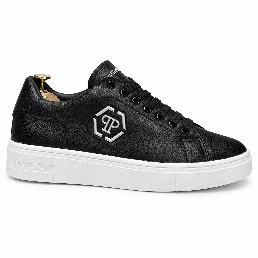 Black lace-up low-top sneaker with side emblem and thick white sole on white background