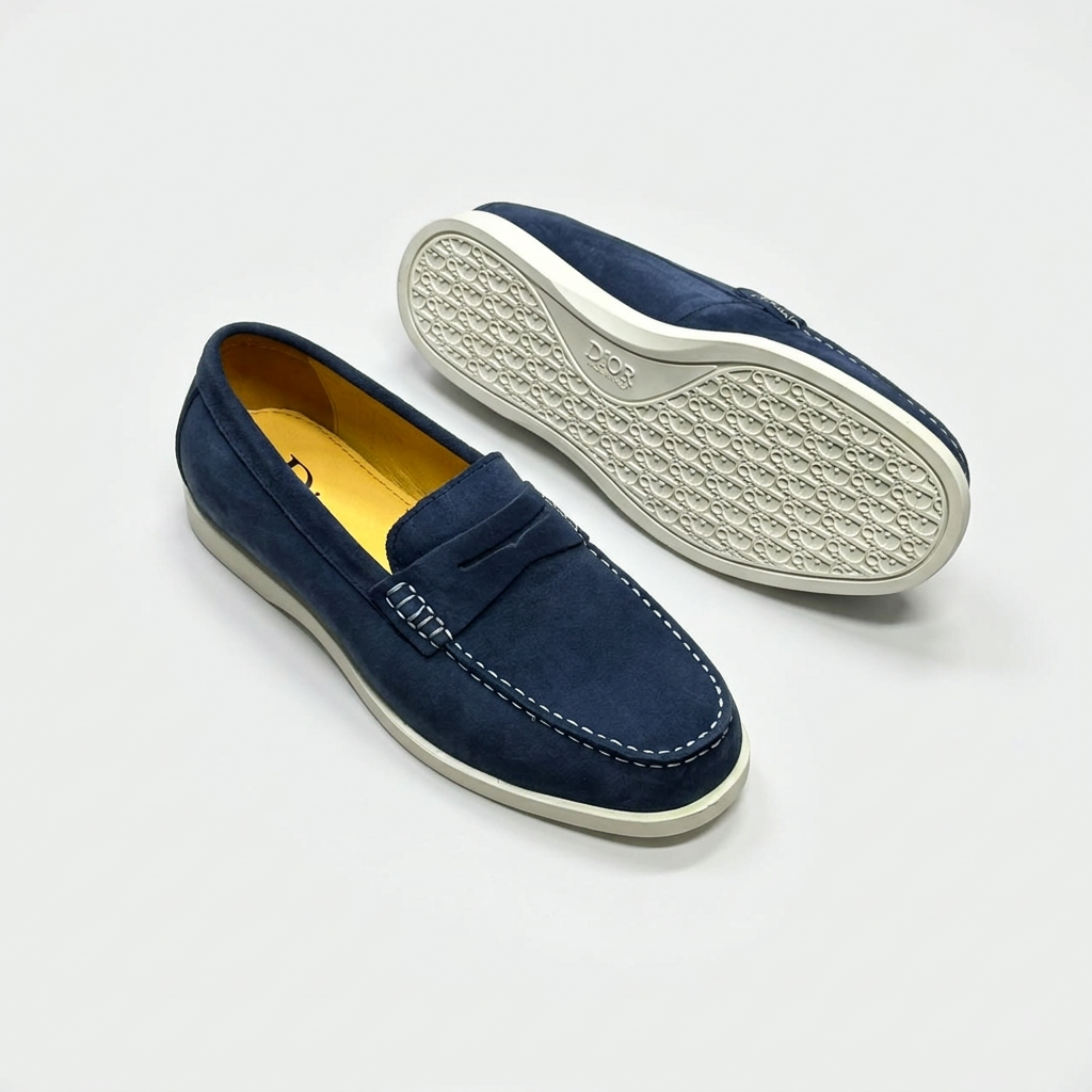 Navy penny loafers with contrast stitching and light-coloured outsole view on white