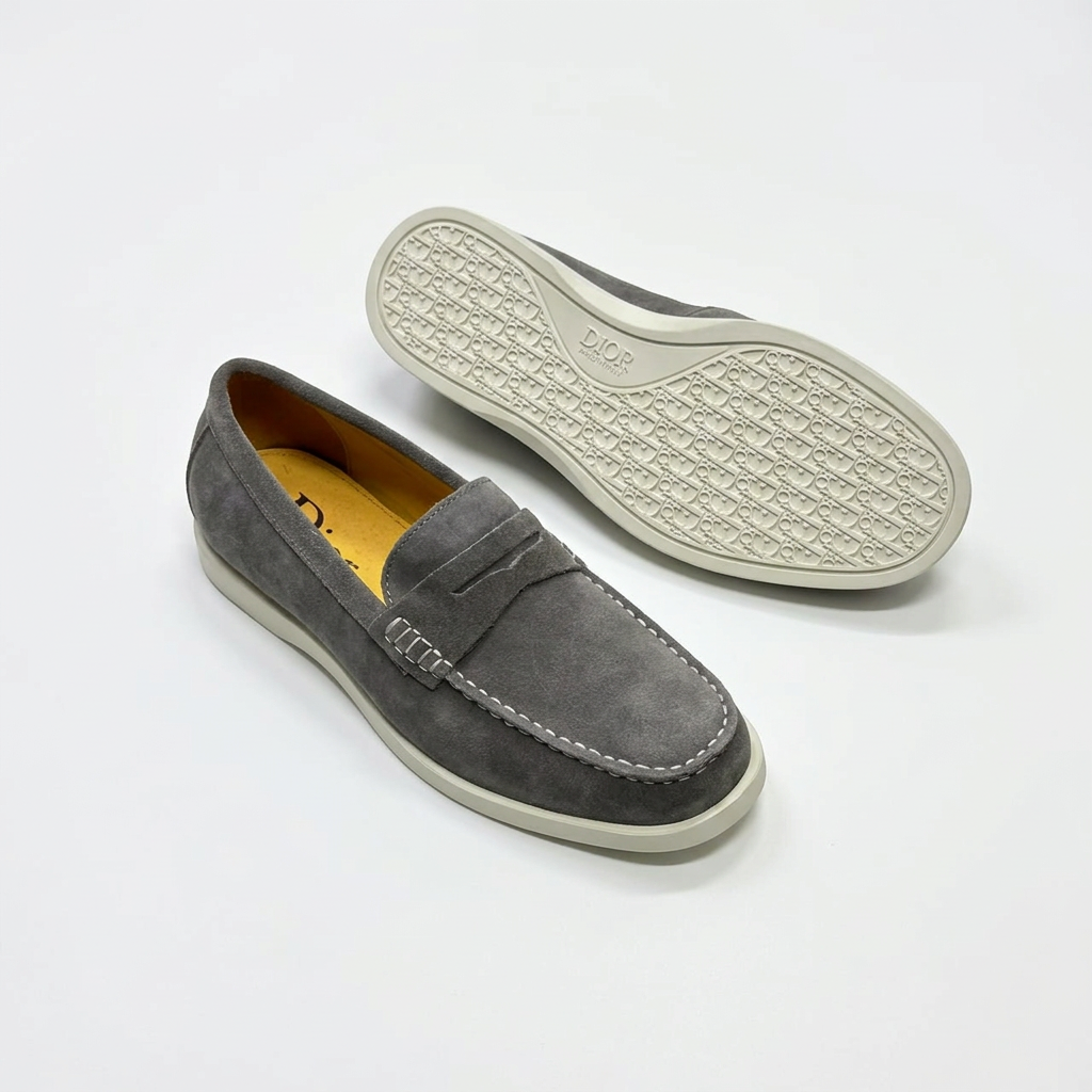 Grey penny loafers with contrast stitching and light-coloured outsole view on white
