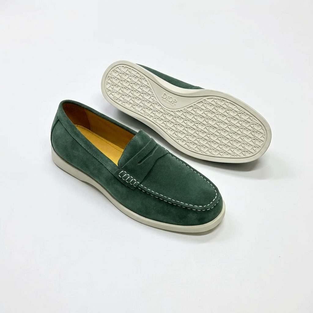 Green penny loafers with contrast stitching and outsole view on white