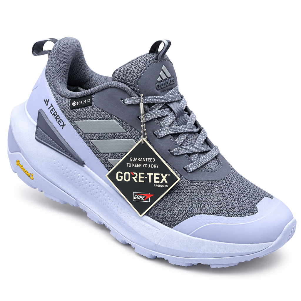 Gray trail sneaker with light sole and hanging product tag on white background