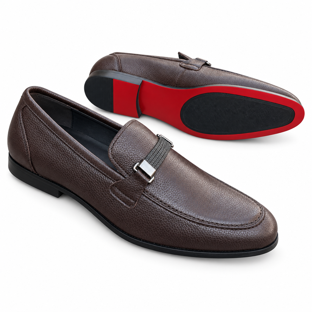 Pair of brown slip-on loafers on white background, front shoe upright and second shoe showing red-and-black outsole