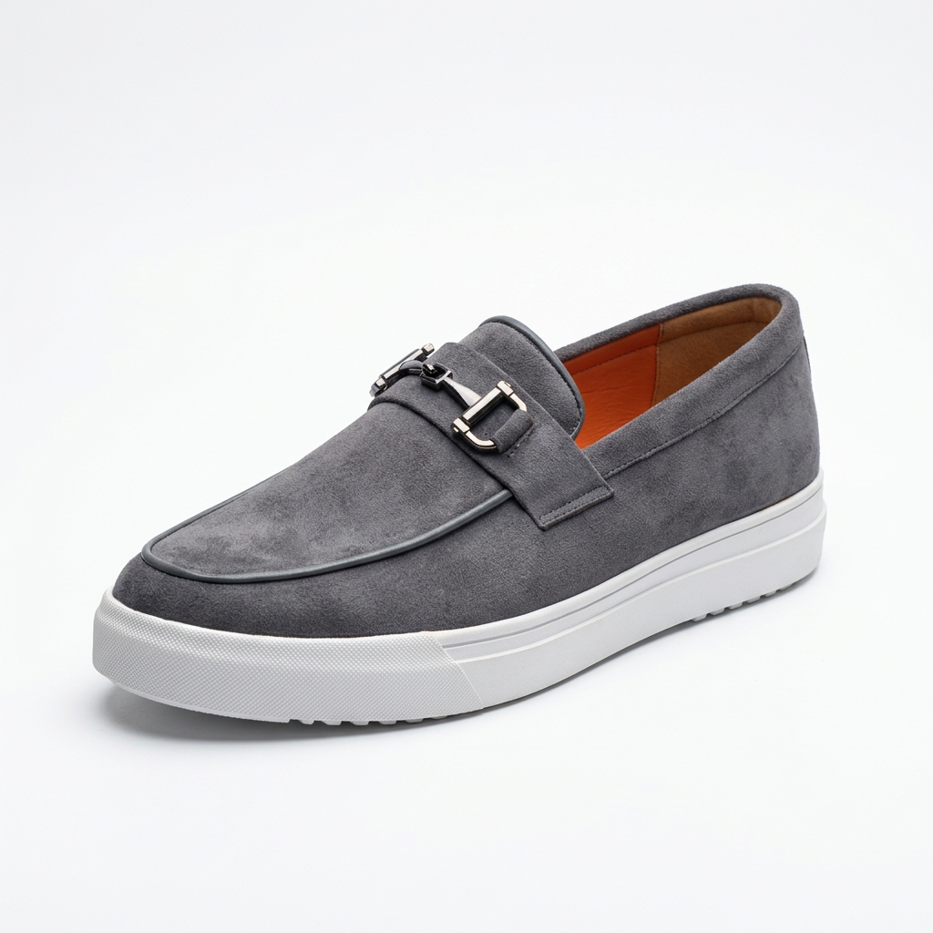 Grey slip-on loafer with metal-bit detail, white sole and orange lining on white