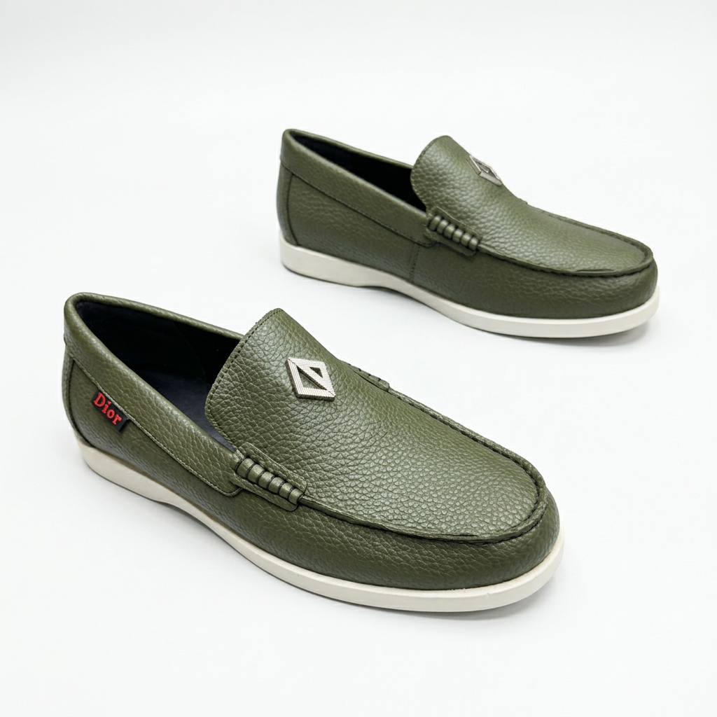 Olive textured slip-on loafers with stitched toes and white soles on white