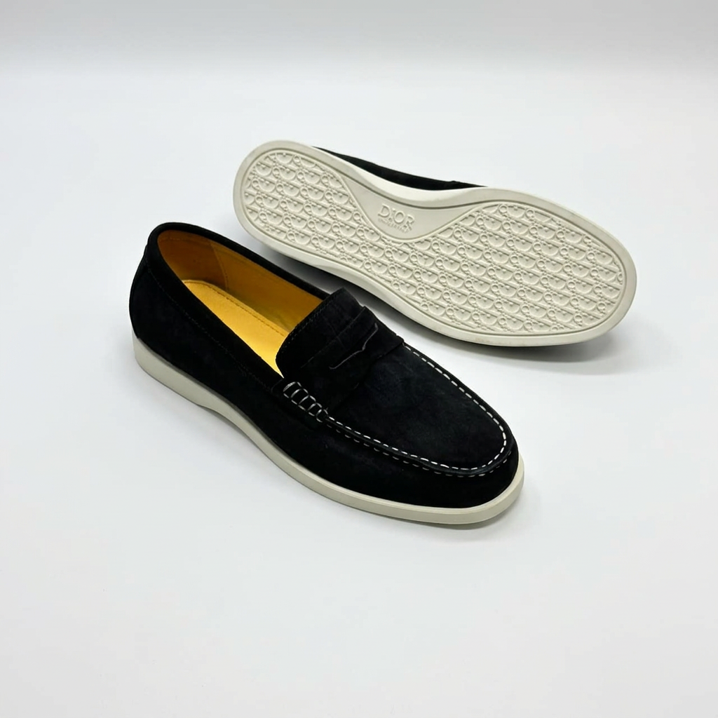 Black penny loafers with contrast stitching and light-coloured outsole view on white