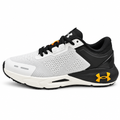 White and black athletic sneaker with orange accents, side view on white background