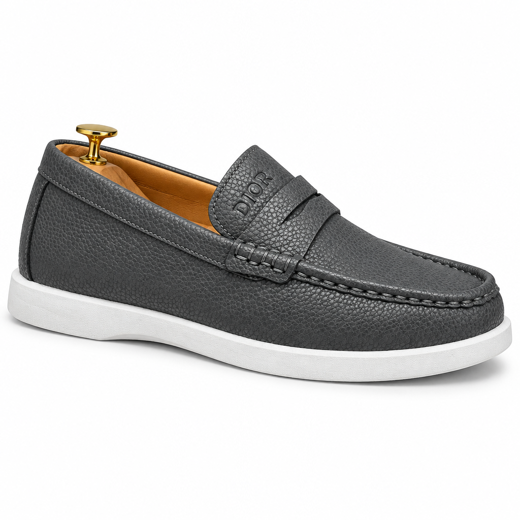 Charcoal-grey textured slip-on penny-style loafer with white sole on white background