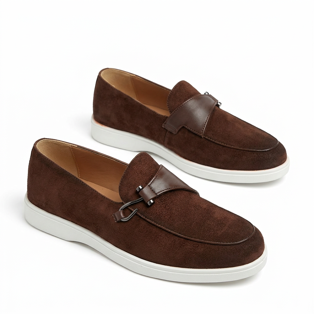 Dark brown slip-on loafers with metal-loop detail and white soles on white
