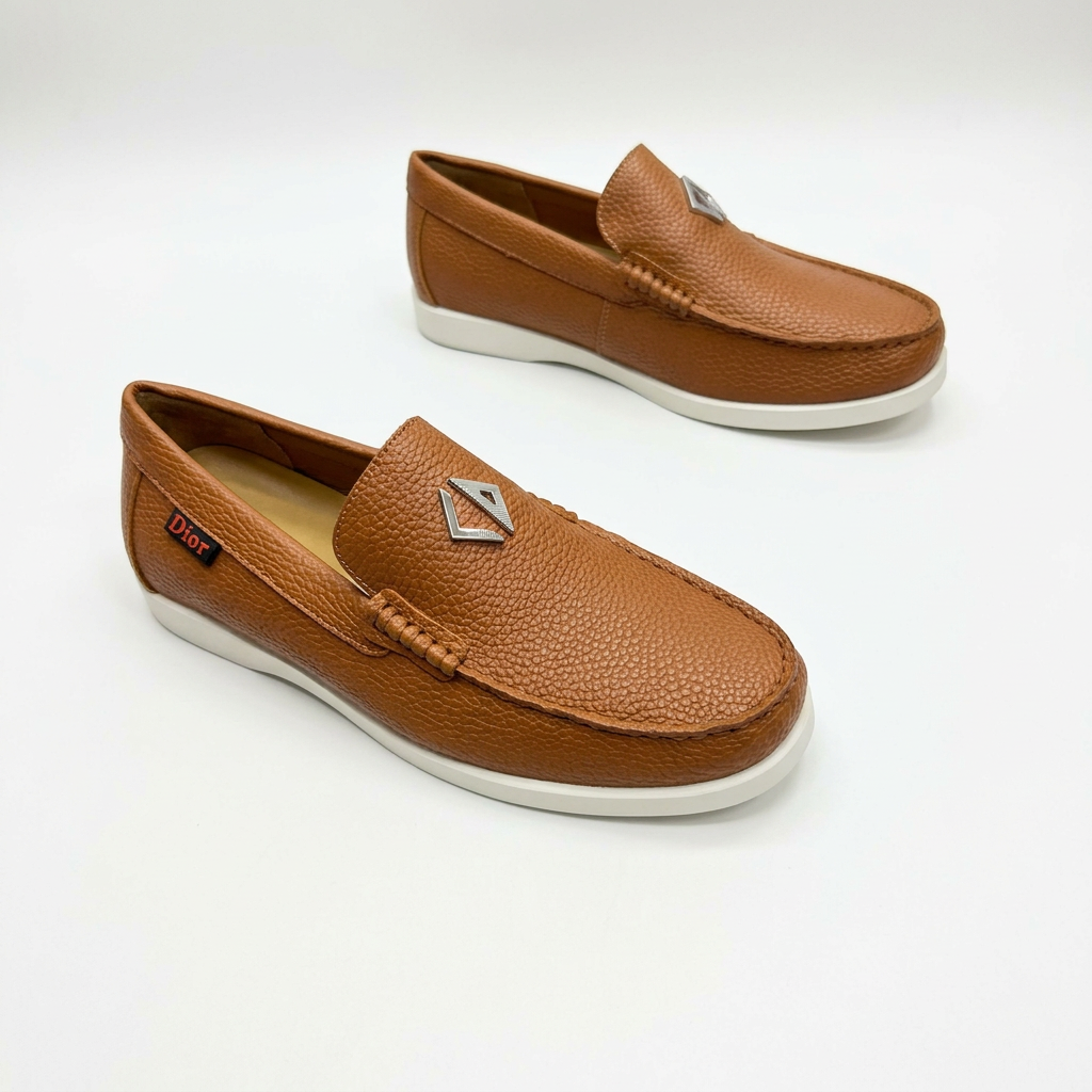 Tan textured slip-on loafers with stitched toes and white soles on white
