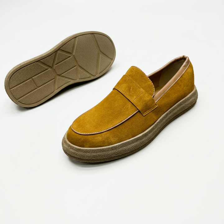 Mustard slip-on loafer with textured sole and geometric outsole view on white