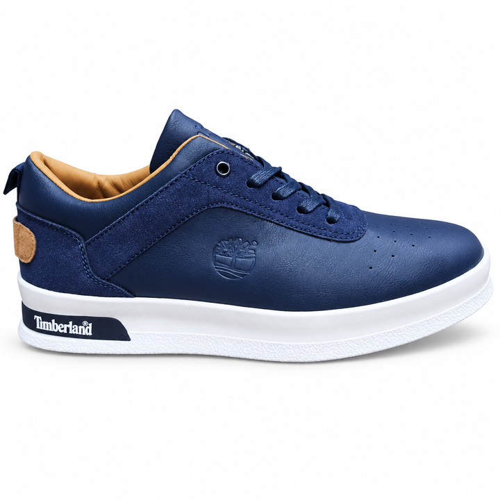 Navy low-top lace-up sneaker with tan lining and white sole on white background