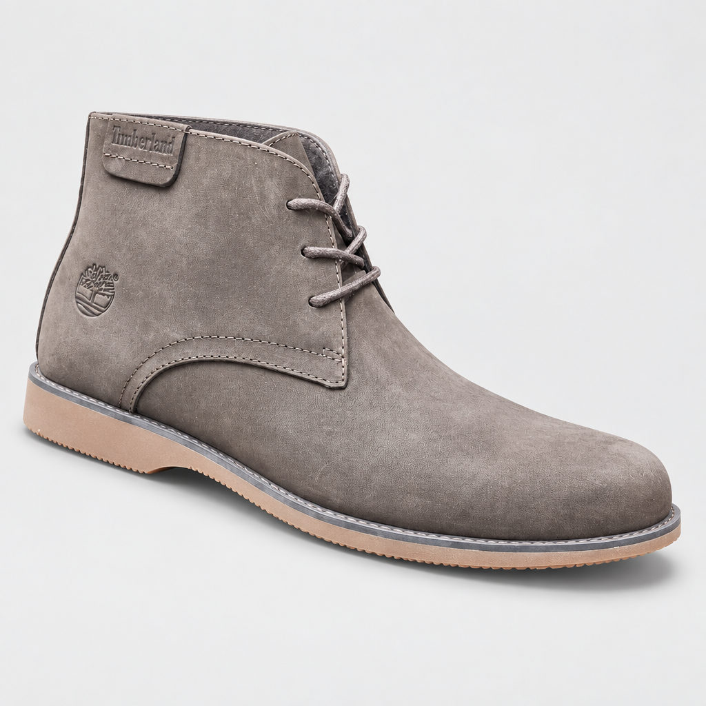 Taupe nubuck chukka boot centered on a neutral studio backdrop with soft shadow